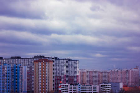 Kyiv, Ukraine. 1 december 2021. Dramatic overcast twilight sky heavy blue violet clouds hanging over the houses in big city. Very peri trendy color sky. Urban cityscape. The skyline with heavy clouds.のeditorial素材