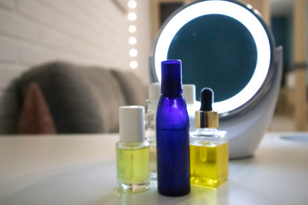 Yellow, blue bottles with natural cosmetics, essential oil, face body skin care aroma oils on white...