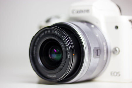 Kyiv, Ukraine. January 7, 2022. White digital mirrorless 4K camera Canon EOS M50 with black lens on...