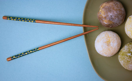 Traditional Japanese dessert mochi in rice dough or daifuku. Four mochi ice cream balls on gray...