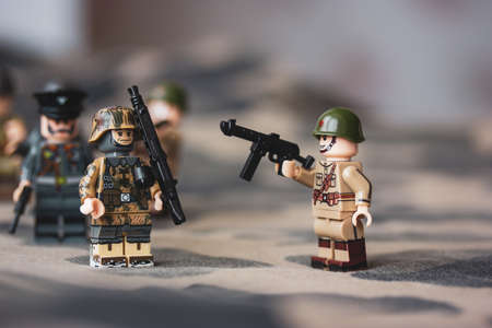Kyiv, Ukraine. March 9, 2022. LEGO soldiers from Second World War. Toy soldier in camouflage uniform with machine gun, weapon. Troops, regiment. War military exercises. Formations of the armed forces.のeditorial素材