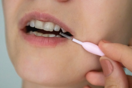 Pink Interdental interproximal brush for brushing teeth for hard-to-reach areas, open female mouth...