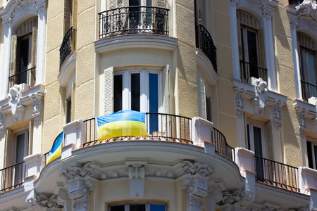 Madrid, Spain. June 1, 2022. Facade of an old residential building on city street. A balcony is decorated with a yellow blue flag of Ukraine. A symbol of support for Ukrainians because of Russia's warのeditorial素材