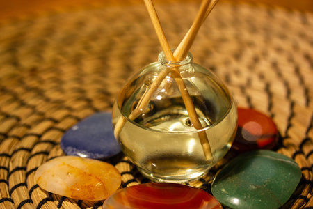 Diffusoria on rattan background. Glass bottle ftv wooden aroma sticks. Fragrance accessory, home...