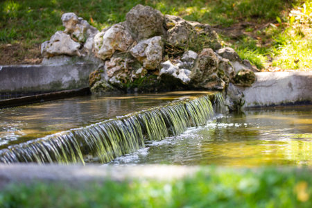 Close up urtificial creek water runs off. Mountain rapids with a stream of water in a river. Little...