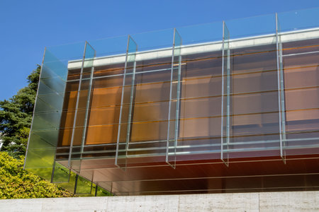 The facade of a modern building with a glass facade. One-story office building in the city, urban...