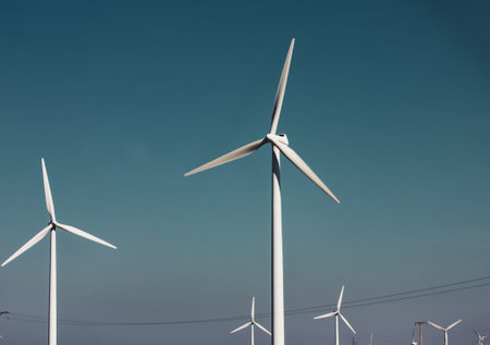 Windmills against a dramatic blue sky. Renewable energy production, ecology, alternative electricity...