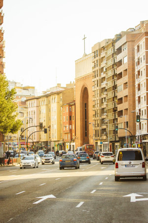 Zaragoza, Spain October 16, 2022 Autumnal city street Residential apartment houses, modern neighborhood. Multifamily buildings. Real estate. Suburb area. Asphalt road in distance with cars movement.のeditorial素材