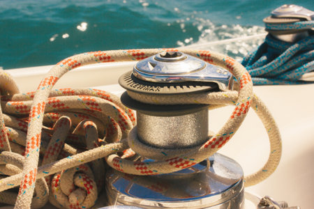 Anchor winch for boats blue rope ropes on the ocean background. Sea travel in summer, adventure, voyage. Ships and yachts details. Pier for mooring. vintage marina theme. luxury summer vacations.の写真素材