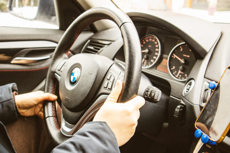 Kyiv Ukraine January 9 2022 Female driver driving BMW car holding steering wheel