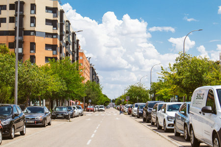 Madrid, Spain. 1 June 2023 A city street with cars parked at a curb in sunny summer day. A free way. Urban space with apartment buildings, houses. Modern Spanish architecture. Quiet calm tranquil areaのeditorial素材