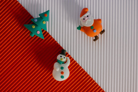 Plasticine miniature figures - Santa Claus, New Year's tree, snowman - cheerful toys on red and...