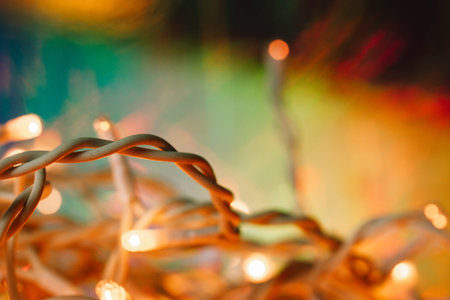 Tangled white wires LED garland for Christmas tree soft focus. New Year 2024 home decor. Warm lights...