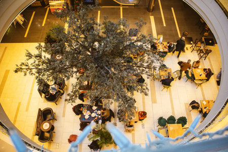People sitting eating in food court, cafe, restaurant in shopping mall top view