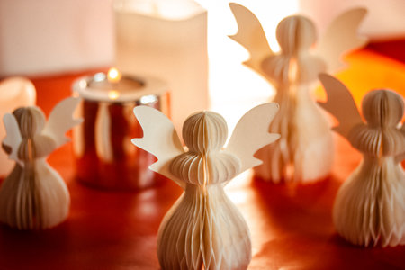 DIY paper angels. Hand made angel on red background. New Year creative toys, candles. Christmas greeting card. Craft decor. Faith and religion conceptの写真素材