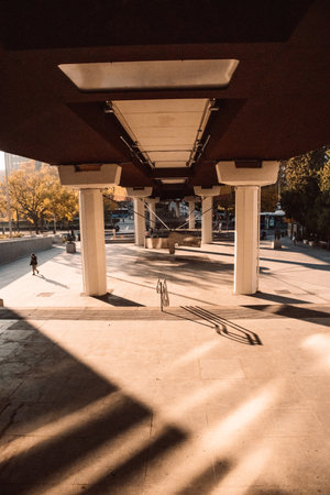 Long shadows, sunlight on a street sidewalk . Business district in golden hour.のeditorial素材