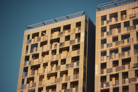 Modern high-rise apartment building facade Tall buildings in a new quarter, neighborhood. Real...
