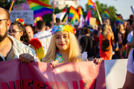 Madrid, Spain. July 3, 2022 A crowd of young people, youth having fun outside at Pride month on gay parade. LGBT rainbow flags. Summer Festival joy.のeditorial素材