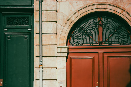 Beautiful antique stone building wall with green and red vintage wooden doors. Cinematic filter old...