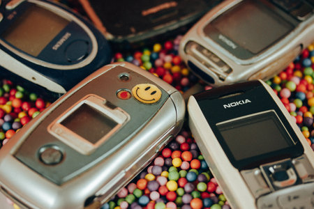 Madrid, Spain. 1 May 2023. Used cell phones. 90s nostalgia. Antique electronics, obsolete devices. Vintage communication. Retro-themed social media.のeditorial素材