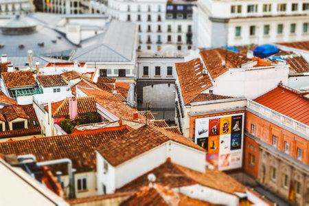 Madrid, Spain. May 1, 2023 Aerial view of red tiled roofs of old houses on European streets. Tilt...