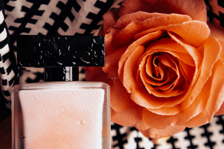 Bottle perfumed water, red lipstick on black white background, blooming fragrant tea rose on table top view. Female beauty concept. Women's lifestyle.の写真素材