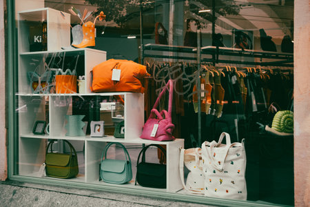 Madrid, Spain. January 1, 2024 Glass storefront window of womens clothing and accessories, handbags. Fashion store, shop display in urban zone.のeditorial素材
