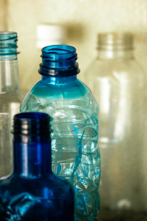 Collection of blue plastic water bottles on blurred background. Recycling plastic to reuse for manufacturing. Zero waste, ecology and planet save.の写真素材
