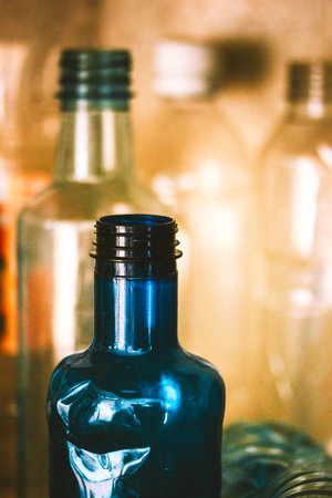 Collection of blue plastic water bottles on blurred background. Recycling plastic to reuse for...