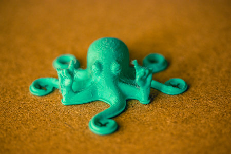 Toy green octopus with tentacles created from recycled plastic. DIY toy character of an underwater world inhabitant. Sea, ocean animal creature.の写真素材