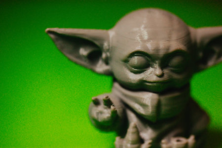 Madrid, Spain 7 May 2024 Din Grogu, Star wars toy hero made of recycling plastic isolated on green...