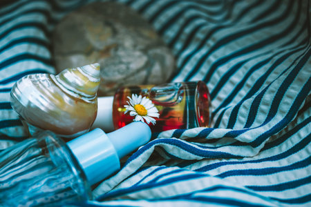 Glass cosmetic bottles with serum. Summer cosmetics for relaxation outdoors. SPF protection product...