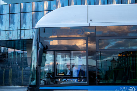 Madrid, Spain. 7 May 2024 Modern electrical low-floor blue bus on a city rout. EMT bus driver on Spanish capital. Municipal vehicle. Urban lifestyle.のeditorial素材