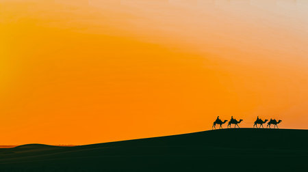 Dark silhouette of caravan with camels on a hilltop against an orange sunset sky. Travel, expedition. Middle Eastern or Central Asian desert landscape.の写真素材