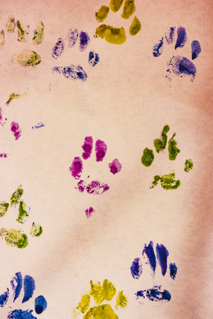 Paws print. Picture drawn with animal paw prints on white paper. Watercolor drawing by a pet. Animal's footprints. Puppy kitty paintの写真素材