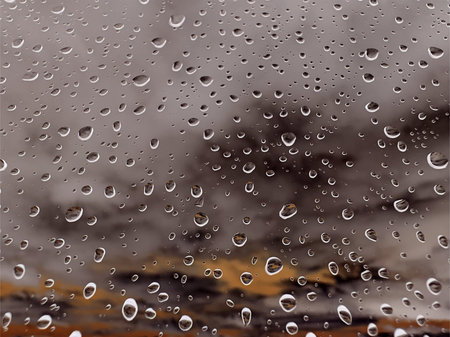 Rainy window glass surface with macro raindrops. Abstract rainy drops in dark autumnal day. Textured...