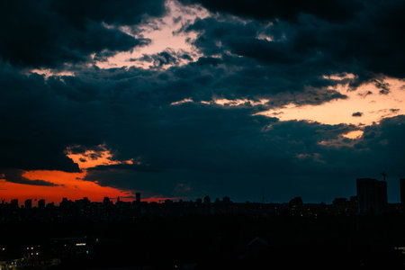 Dark evening blue-red sky and the silhouette of high-rise buildings on the horizon. Evening...