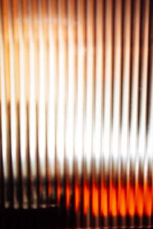 An abstract composition with vertical lines and blurred light, creating a sense of depth. The colors transition from warm to cool tones Blurred backdropの写真素材
