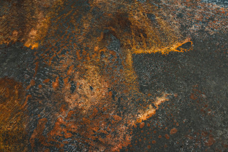 A detailed view of textured and weathered metal surface with rust and gray elements This abstract...