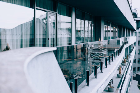 Stylish apartment building with contemporary unique balcony design, reflective glass windows and modern architecture. A building with a long balcony.の写真素材