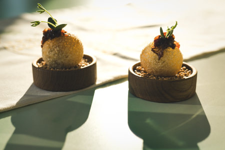 Elegant culinary presentation features appetizers with fresh herbs, artistic plating on a restaurant table. A fine dining with a touch of elegance.の写真素材