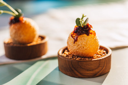 Elegant culinary presentation features appetizers with fresh herbs, artistic plating on a restaurant table. A fine dining with a touch of elegance.の写真素材