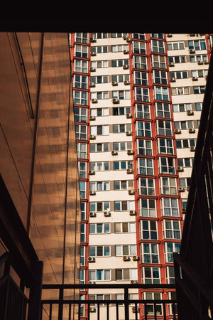 A modern apartment building with many windows, viewed from the staircase. Architectural photograph...