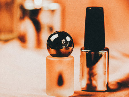 Close-up of nail polish bottles on a soft, textured surface. Two bottles of nail polish are displayed in a warm, inviting light, perfect for beauty and fashion concepts. Cuticle oilの写真素材