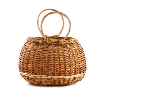 Wicker vintage willow basket, isolated on white backgroundの写真素材