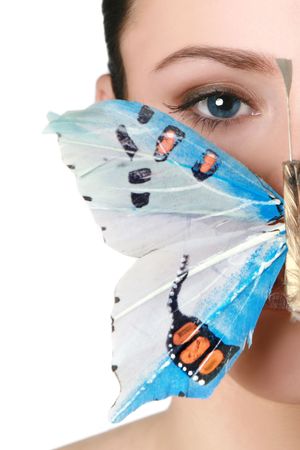 Blue-eyed brunette with a butterfly on the mouthの写真素材