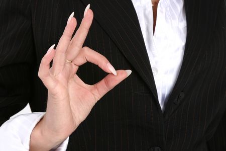 Business female showing an OK signの写真素材