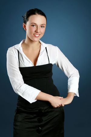 Portrait of a gorgeous teacher over dark-blue backgroundの写真素材