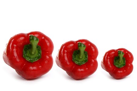 Three red bulgarian pepper with water drops over white backgroundの写真素材