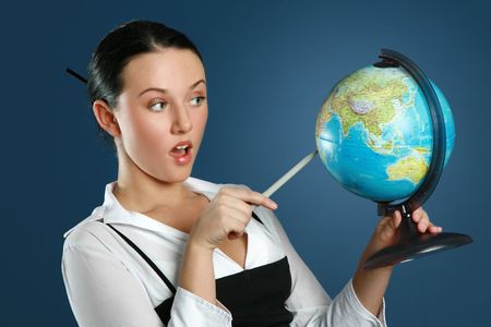Close-up portrait of a gorgeous teacher with globeの写真素材